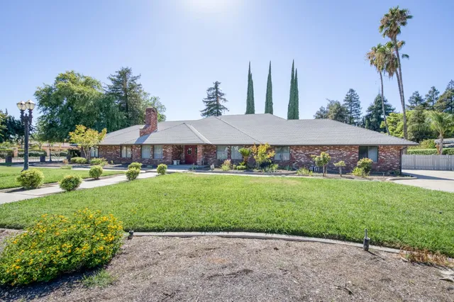 a kitchen with stainless steel appliances granite countertop a sink and a refrigerator