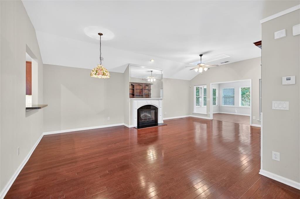 164 Cottage Club Drive Locust Grove, GA 30248 - Photo 12 of 56 a view of empty room with wooden floor and fireplace