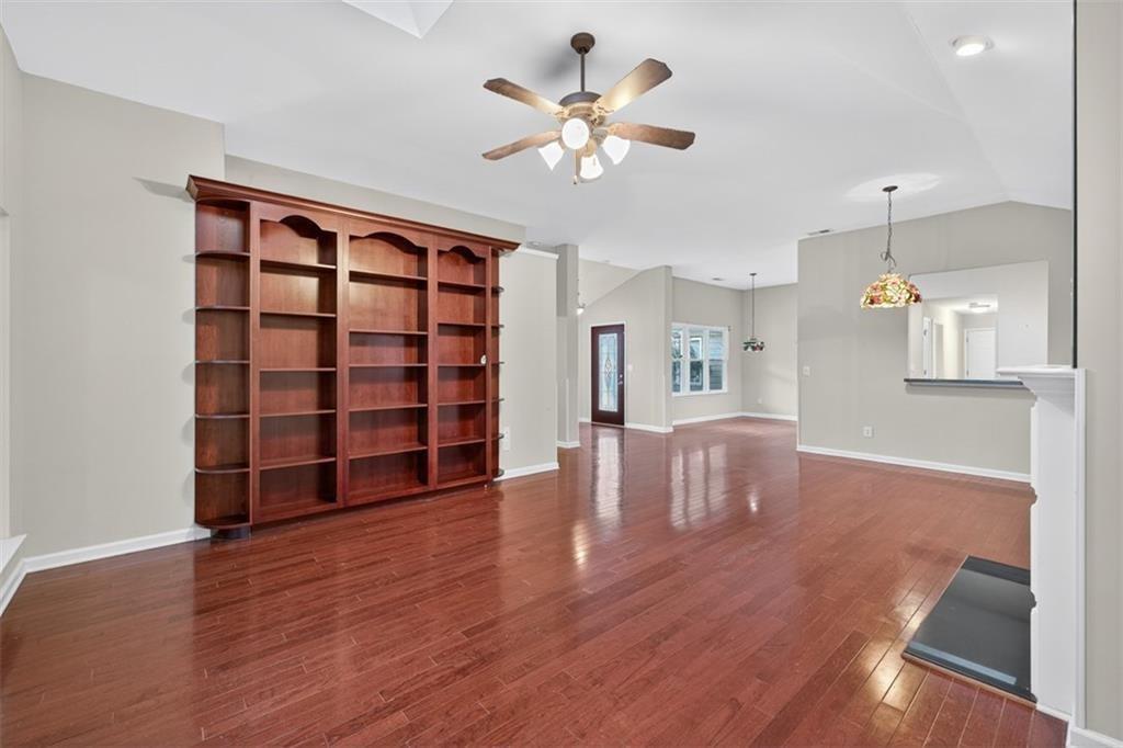 164 Cottage Club Drive Locust Grove, GA 30248 - Photo 16 of 56 a view of an empty room with a window and wooden floor