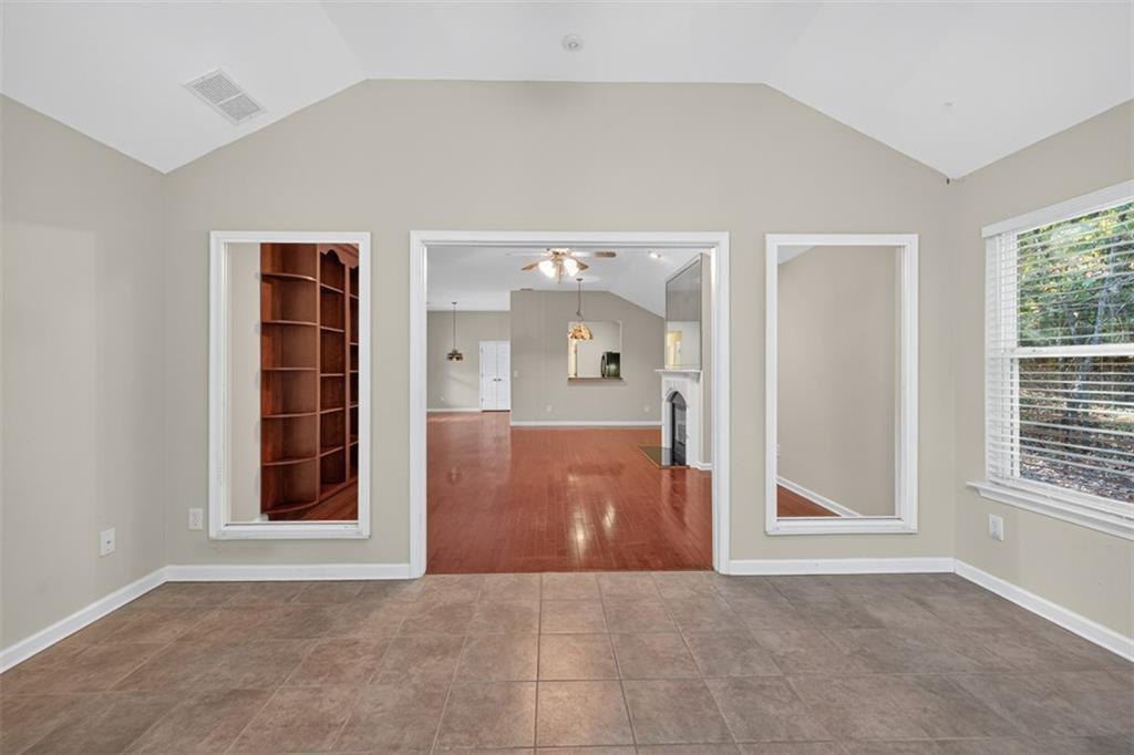 164 Cottage Club Drive Locust Grove, GA 30248 - Photo 20 of 56 an empty room with windows and cabinet