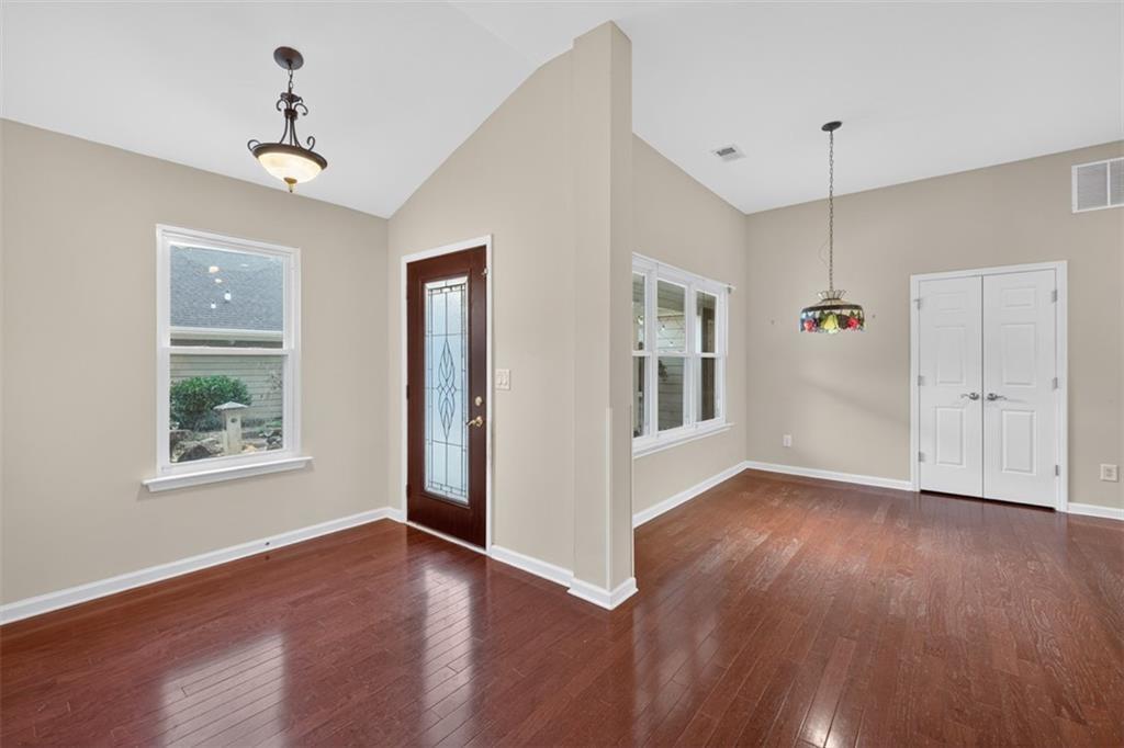 164 Cottage Club Drive Locust Grove, GA 30248 - Photo 21 of 56 a view of an empty room with window and wooden floor