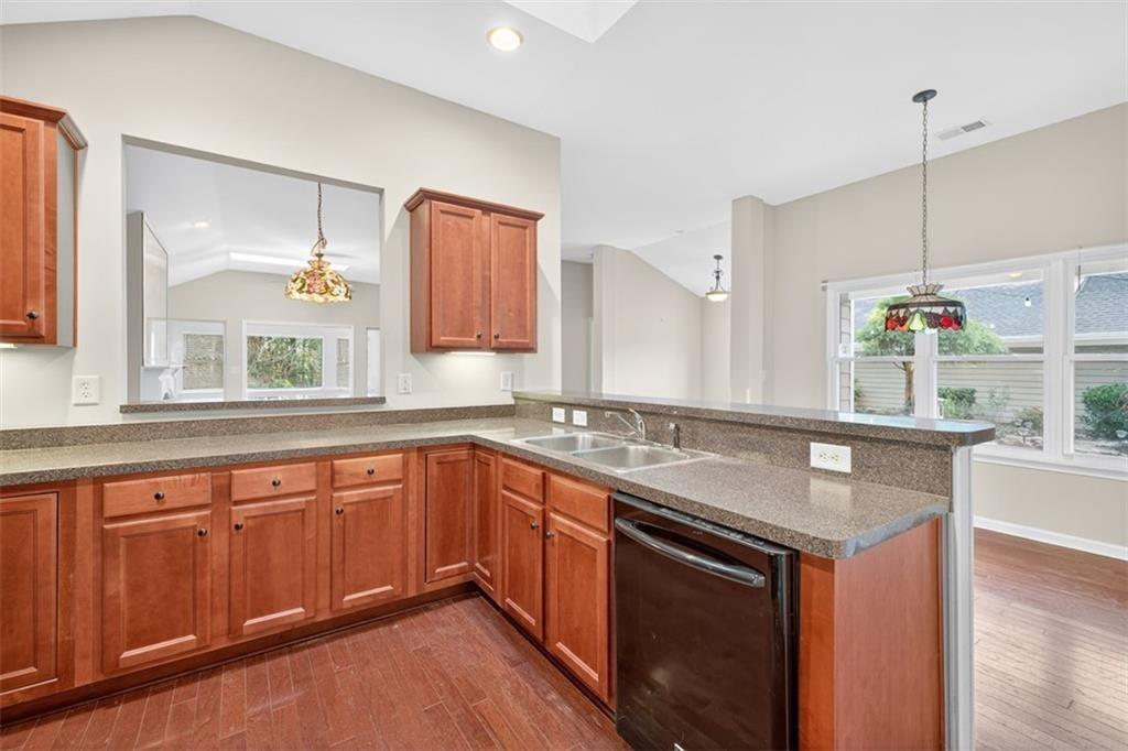164 Cottage Club Drive Locust Grove, GA 30248 - Photo 25 of 56 a kitchen with stainless steel appliances granite countertop a sink stove and wooden floor