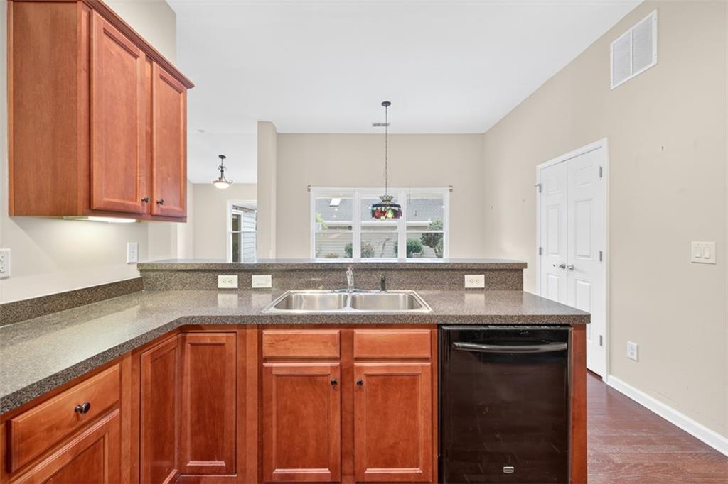 164 Cottage Club Drive Locust Grove, GA 30248 - Photo 26 of 56 a kitchen with granite countertop a sink and cabinets
