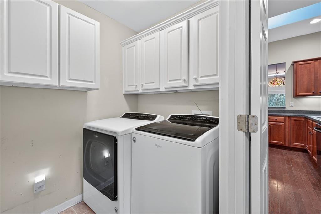 164 Cottage Club Drive Locust Grove, GA 30248 - Photo 30 of 56 a kitchen with white cabinets and sink
