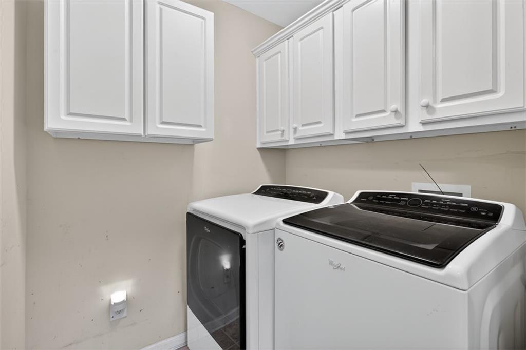 164 Cottage Club Drive Locust Grove, GA 30248 - Photo 31 of 56 a kitchen with granite countertop white cabinets and a stove