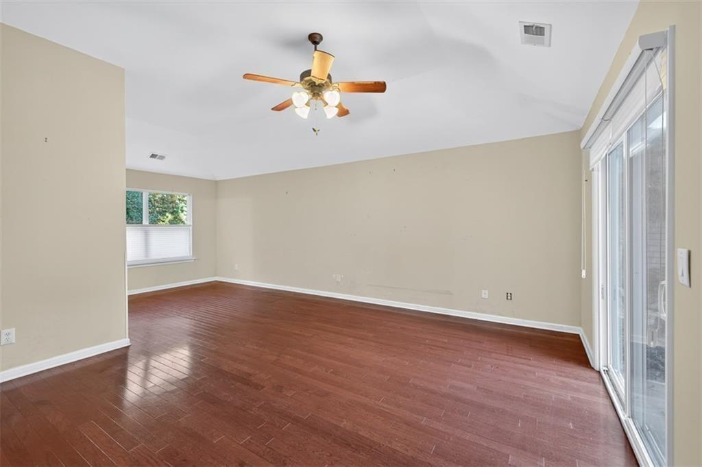 164 Cottage Club Drive Locust Grove, GA 30248 - Photo 33 of 56 an empty room with wooden floor and windows
