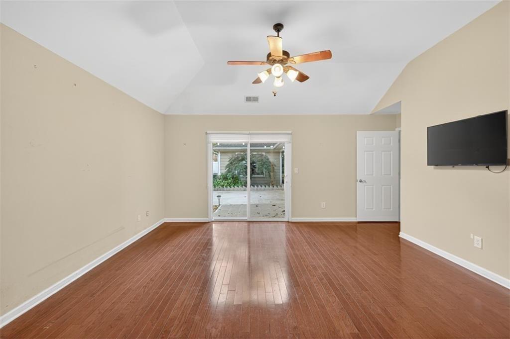 164 Cottage Club Drive Locust Grove, GA 30248 - Photo 35 of 56 a view of an empty room with wooden floor and a window