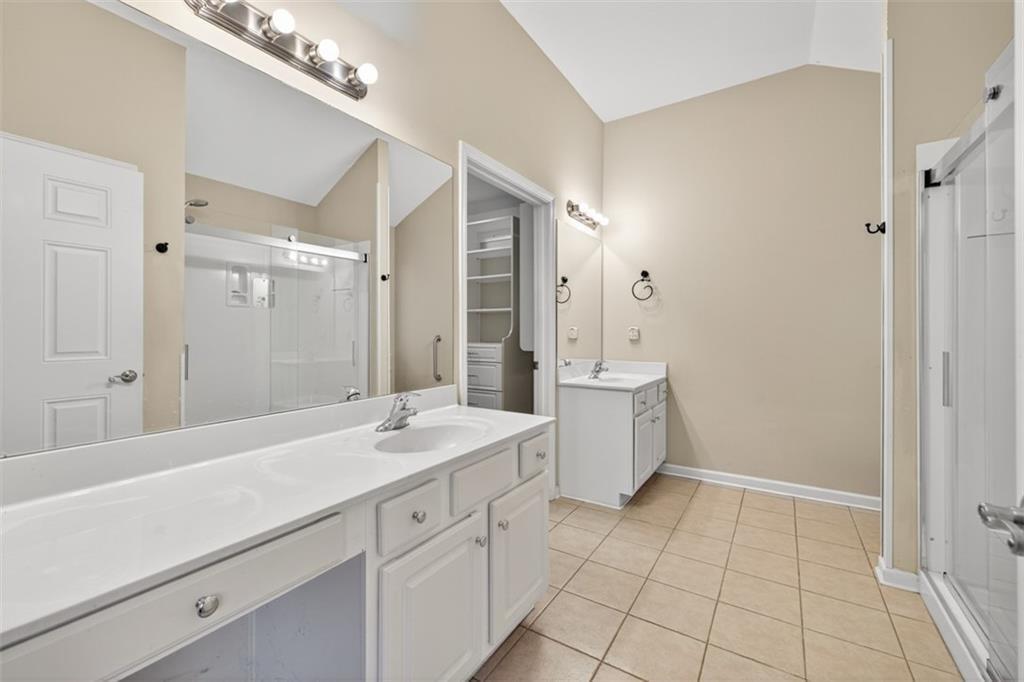 164 Cottage Club Drive Locust Grove, GA 30248 - Photo 37 of 56 a spacious bathroom with a sink a mirror and a shower