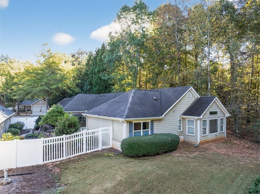 164 Cottage Club Drive Locust Grove, GA 30248 - Photo 47 of 56 a view of house with garden and tall trees