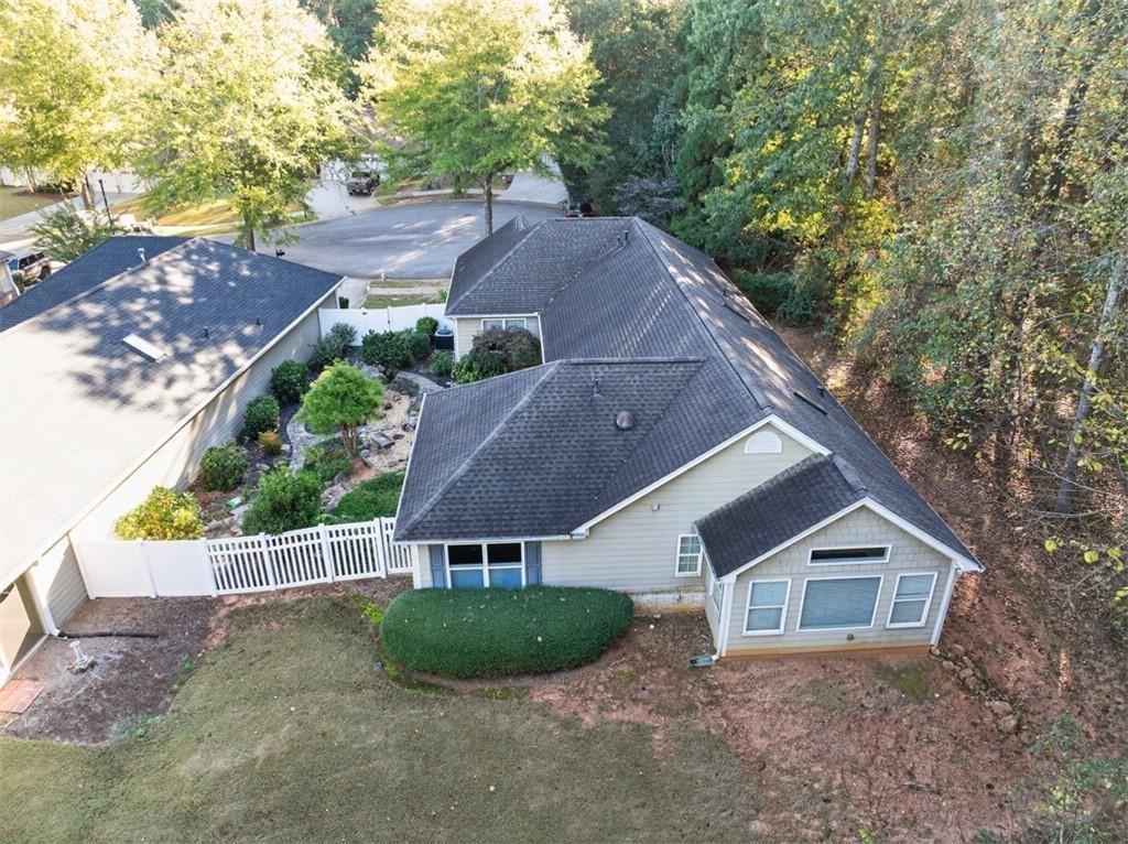 164 Cottage Club Drive Locust Grove, GA 30248 - Photo 48 of 56 an aerial view of house with yard and trees in the background