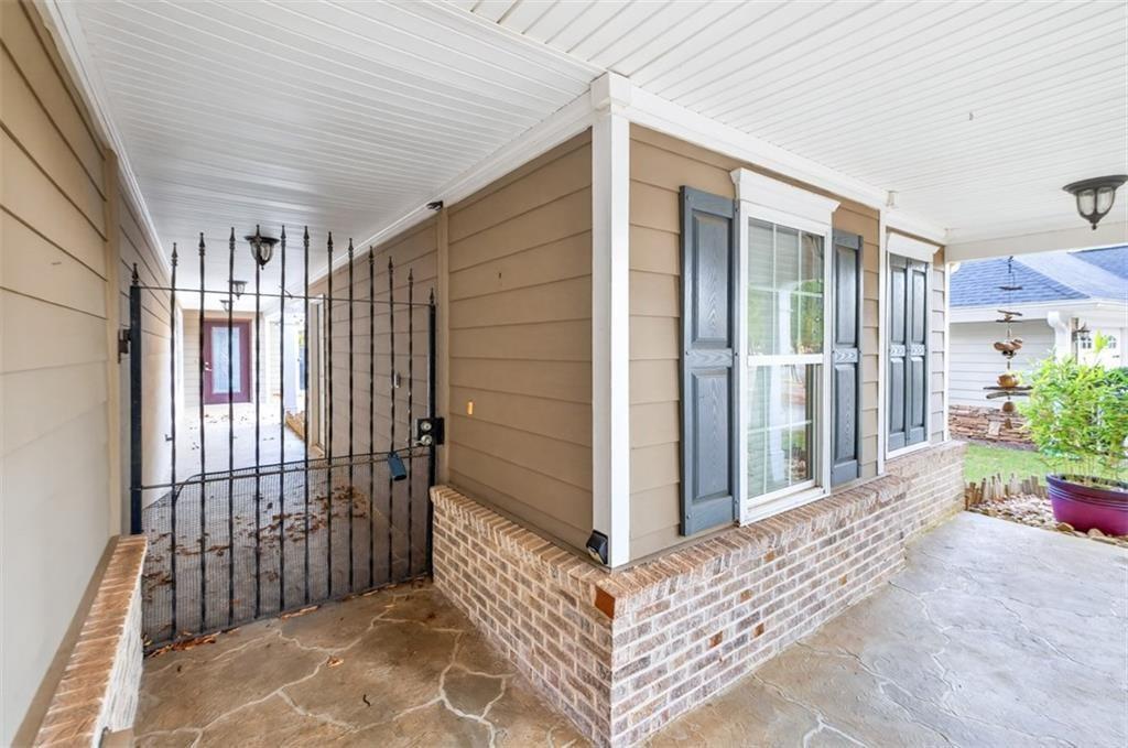 164 Cottage Club Drive Locust Grove, GA 30248 - Photo 5 of 56 a view of a porch with wooden floor and fence