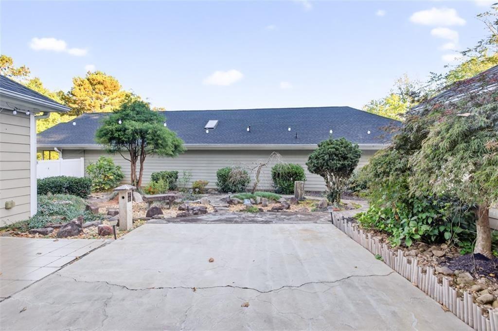 164 Cottage Club Drive Locust Grove, GA 30248 - Photo 6 of 56 a view of a patio with dining table and chairs under an umbrella
