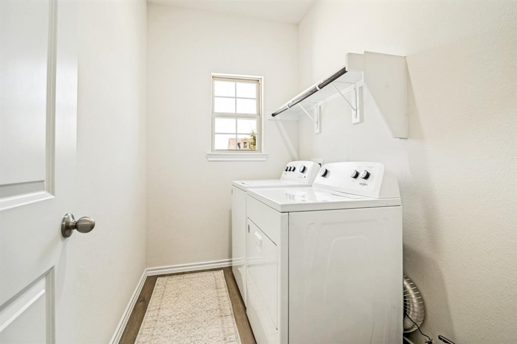 609 Nature Stroll Road Lavon, TX 75166 - Photo 11 of 13 Dedicated utility room featuring wood-finish flooring, a window with natural light, and a functional hanging rod with shelving
