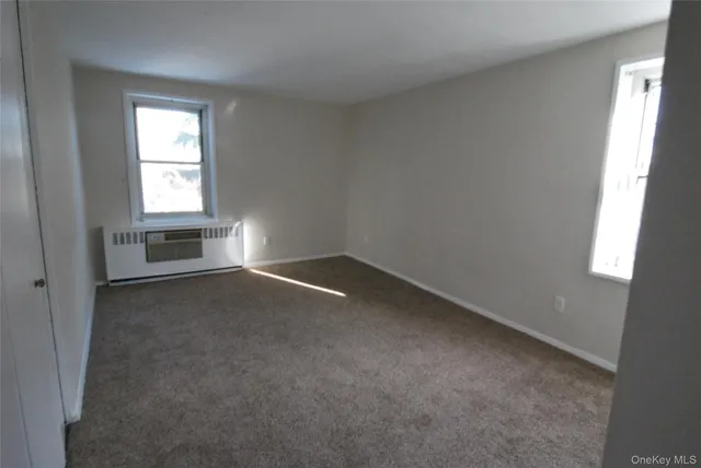 an empty room with a empty space and windows