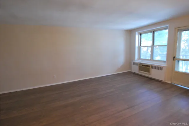 wooden floor and window in an empty room