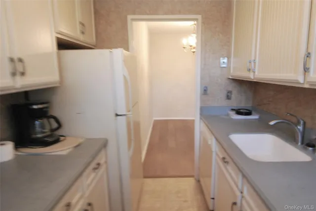 a kitchen with refrigerator and cabinets