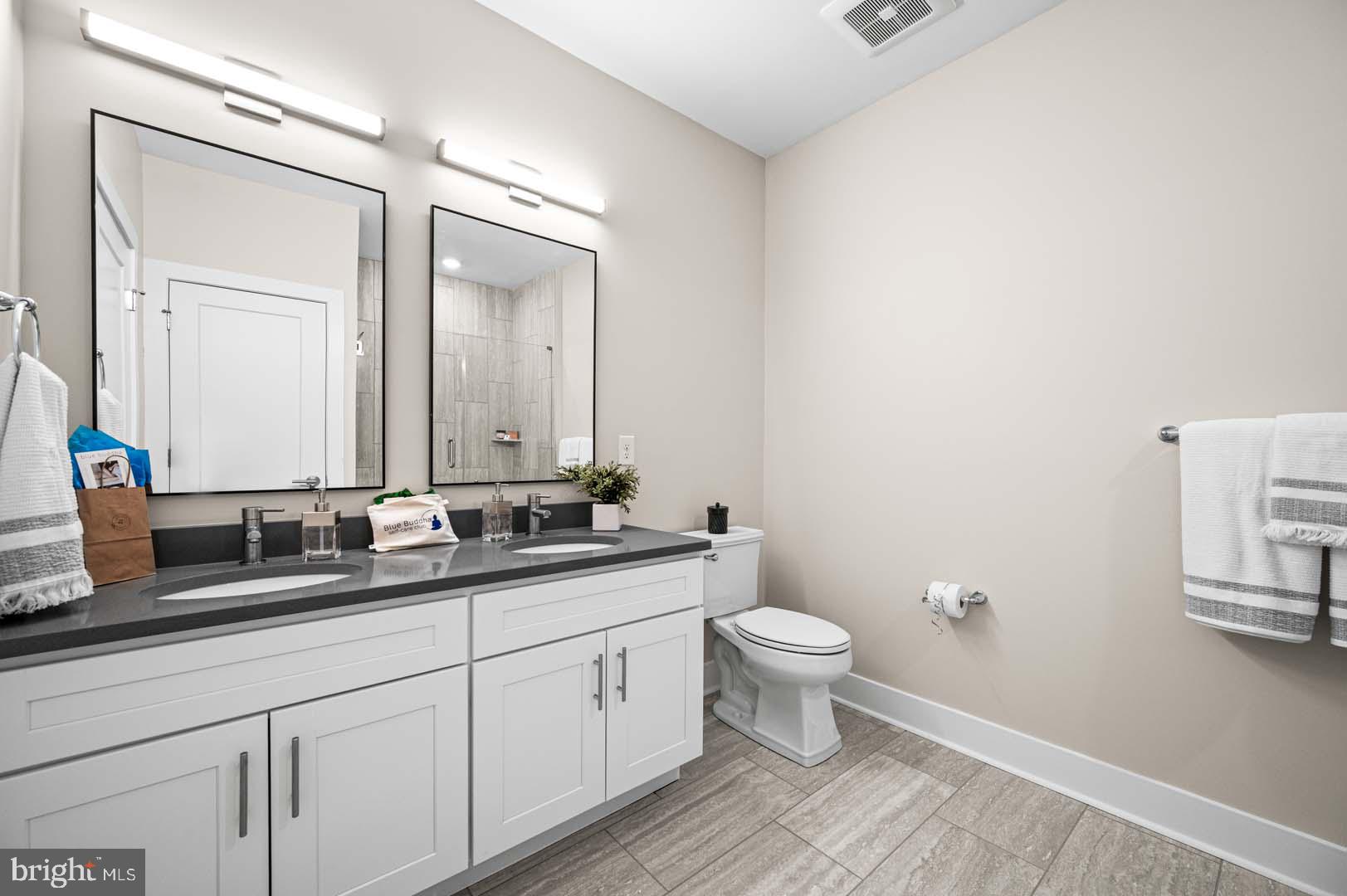 703 Rice Boulevard, Unit 103 Exton, PA 19341 - Photo 6 of 10 Sleek modern bathroom with dual mirrors.