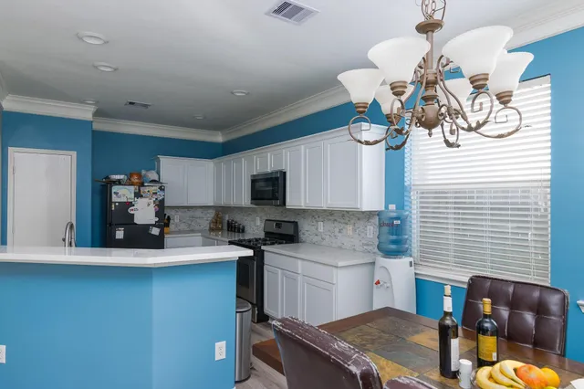 a kitchen with a sink appliances and cabinets
