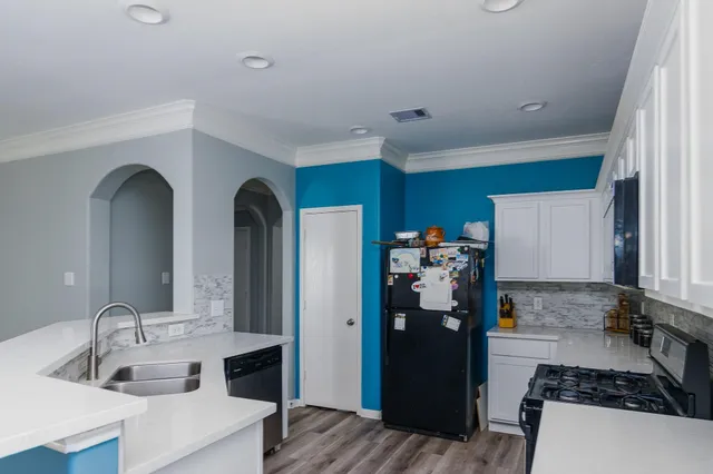 a kitchen with refrigerator and sink