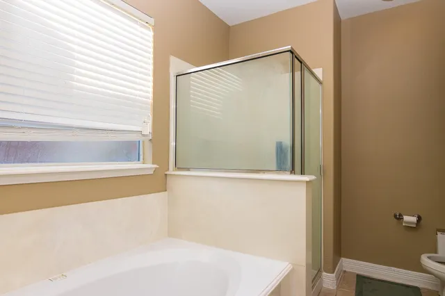 a bathroom with a bathtub and a shower