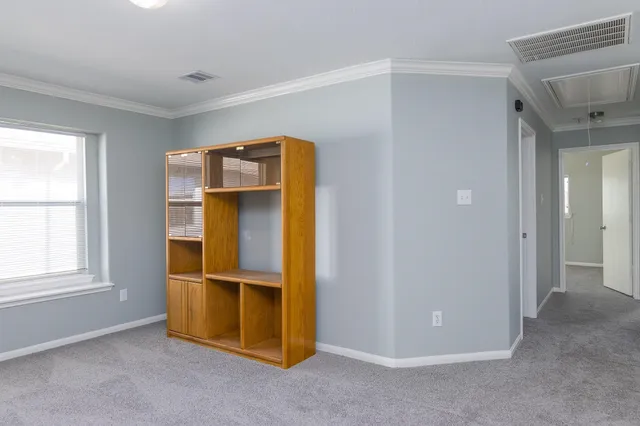 an empty room with windows and closet