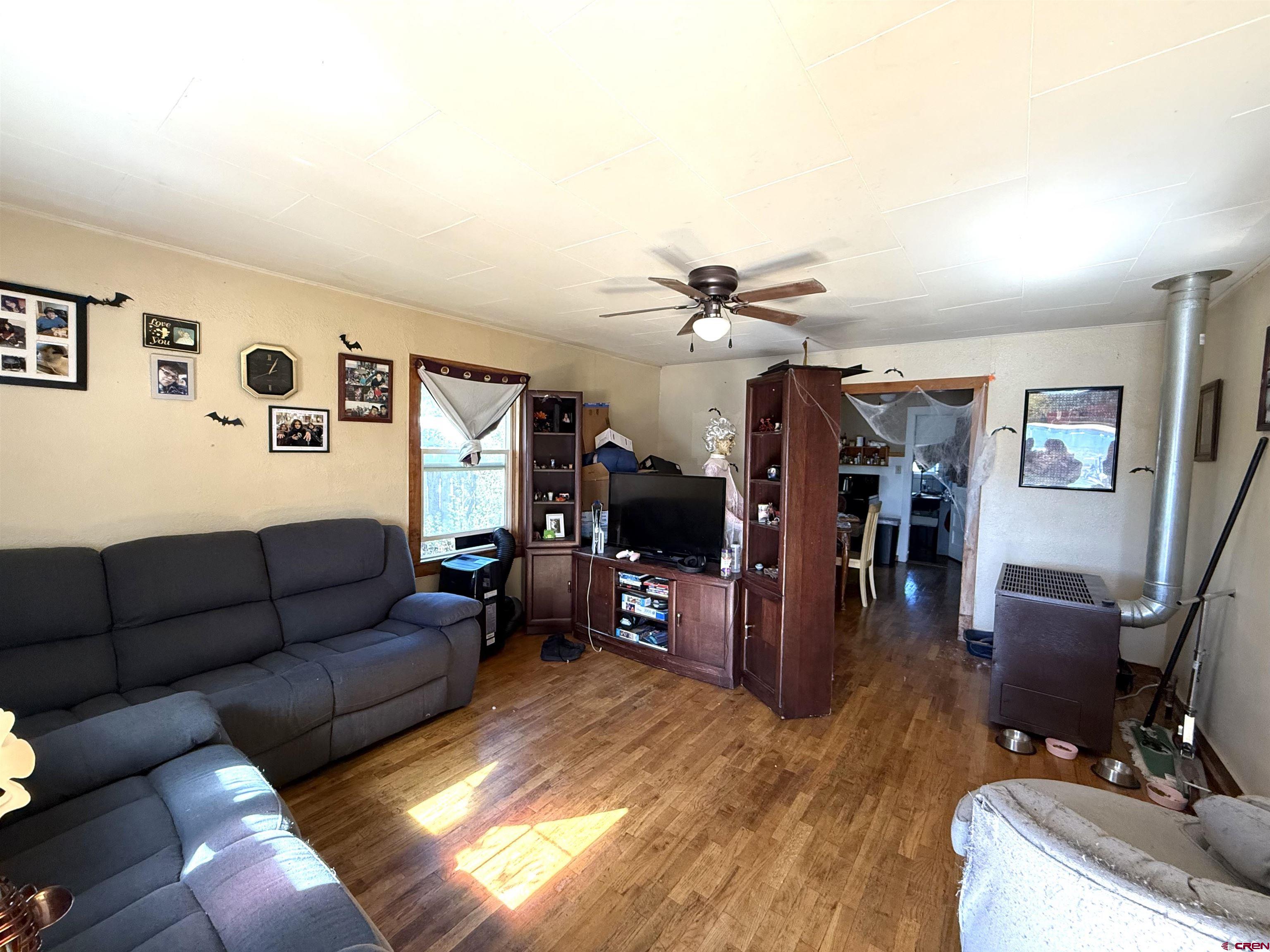 1118 East Main Street Cortez, CO 81321 - Photo 11 of 15 a living room with furniture and wooden floor