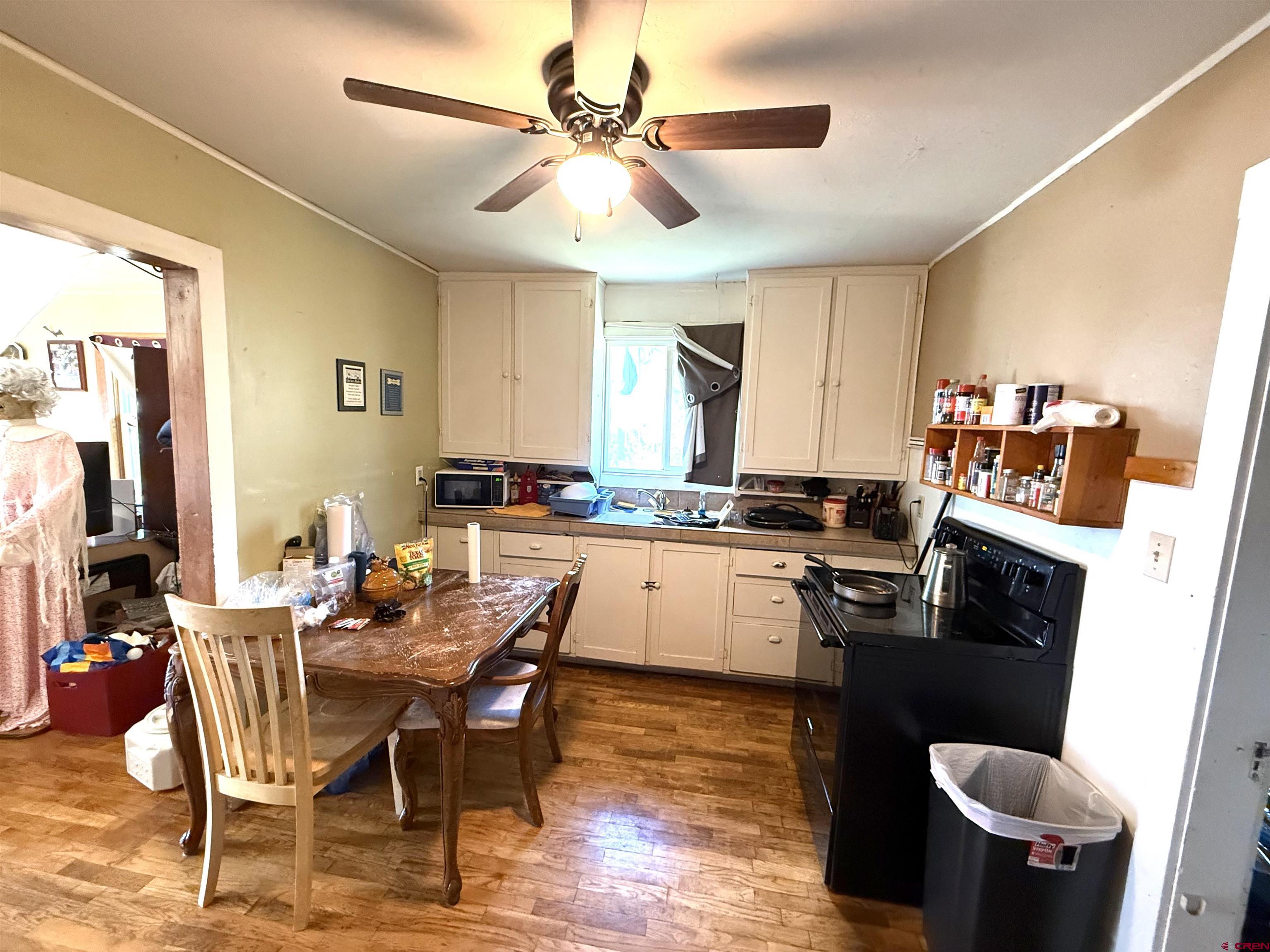 1118 East Main Street Cortez, CO 81321 - Photo 12 of 15 a kitchen with a dining table chairs and a refrigerator
