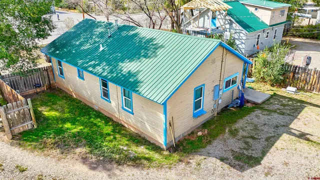 a view of a house with backyard and deck