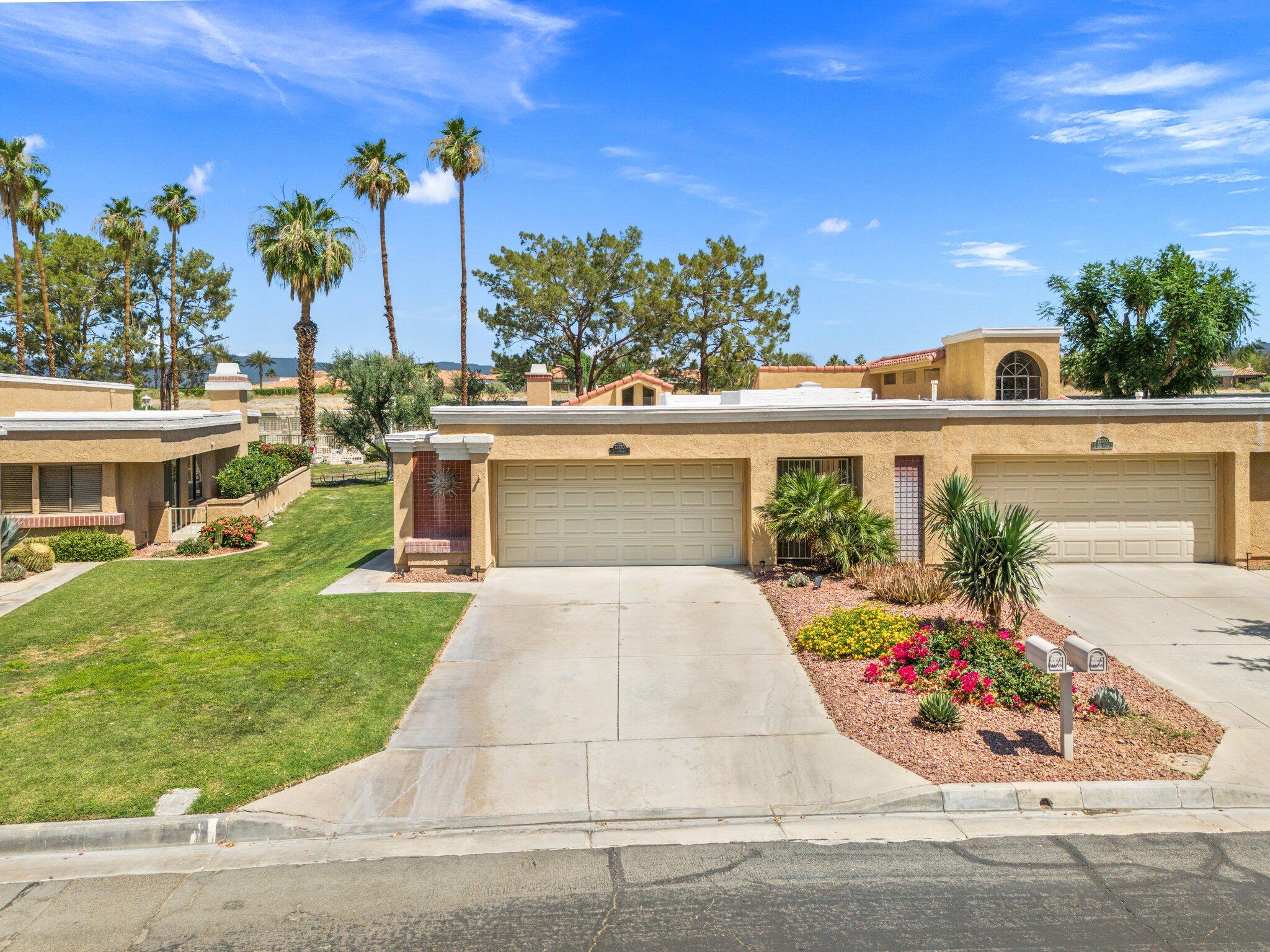 73750 Calle Bisque Palm Desert, CA 92260 - Photo 1 of 40 front view of a house with a yard