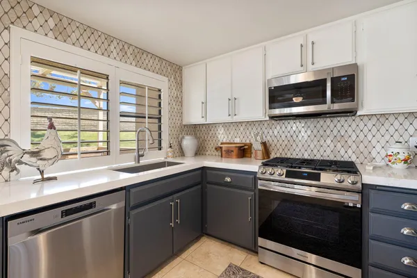 a kitchen with a sink stove and microwave