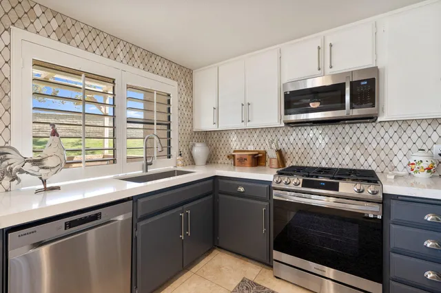 a kitchen with a sink stove and microwave