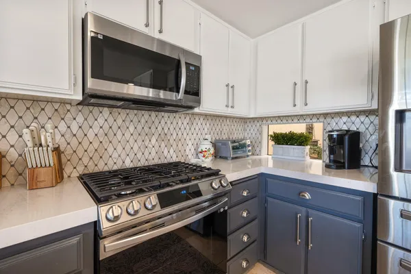 a kitchen with a stove and a microwave