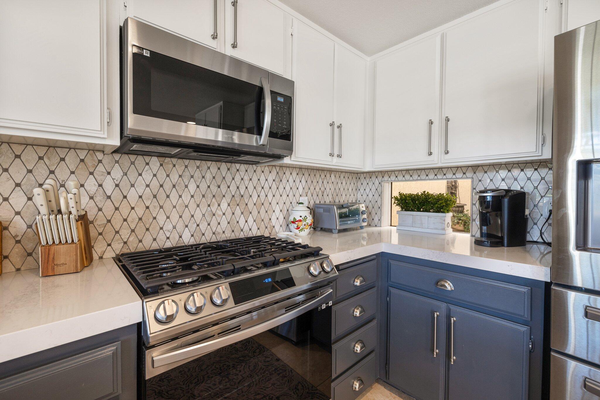 73750 Calle Bisque Palm Desert, CA 92260 - Photo 13 of 40 a kitchen with a stove and a microwave
