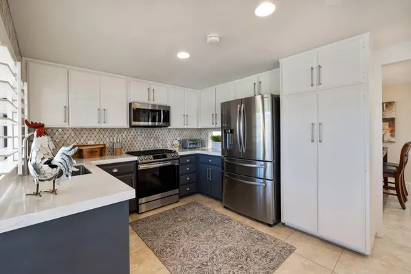 a kitchen with a refrigerator stove and sink