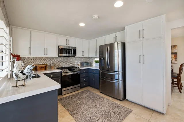 a kitchen with a refrigerator stove and sink