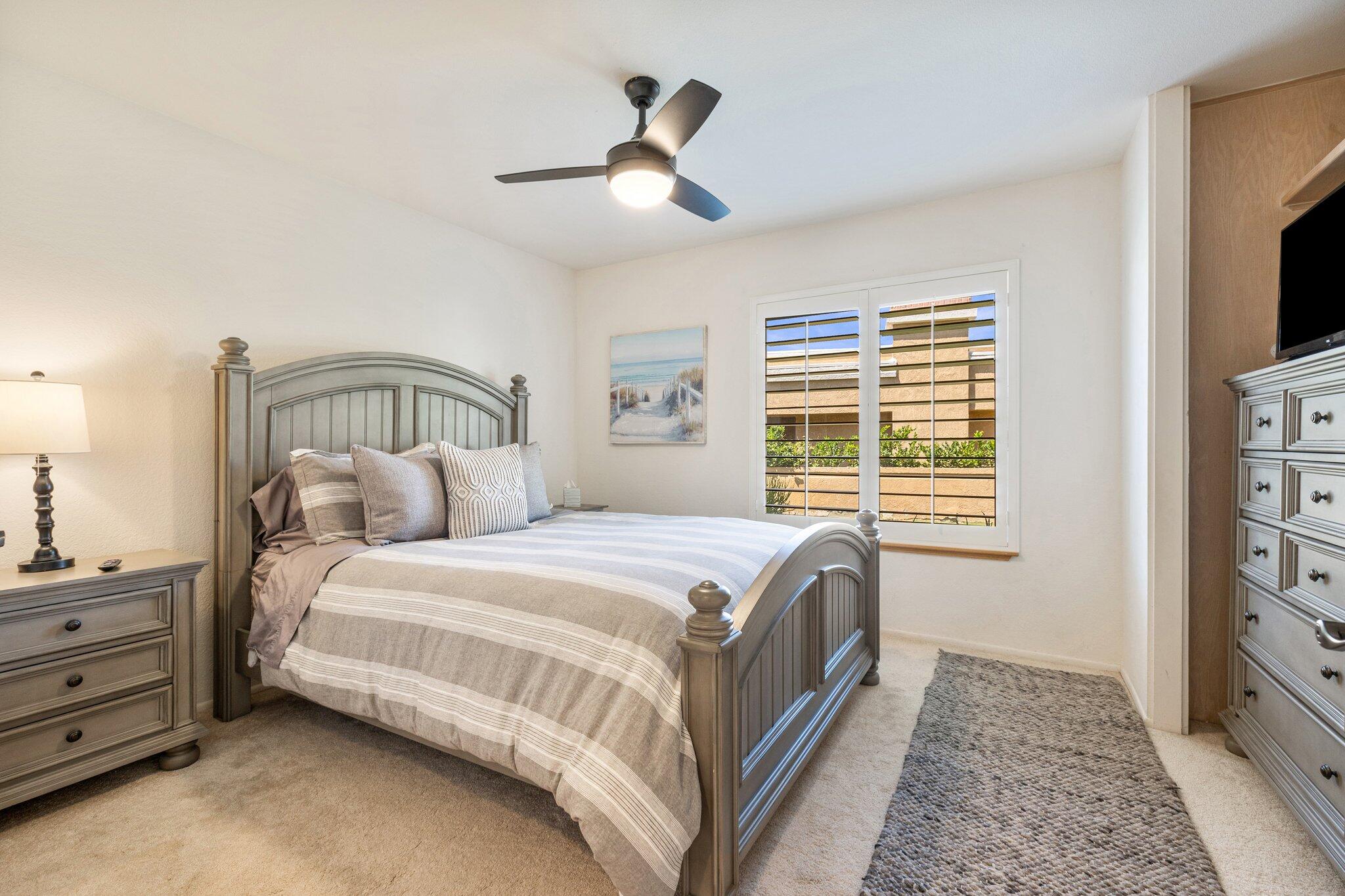 73750 Calle Bisque Palm Desert, CA 92260 - Photo 16 of 40 a bedroom with a bed and a flat tv screen on dresser