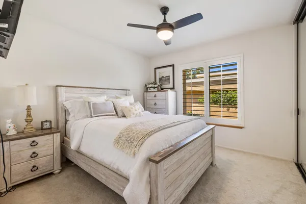 a bedroom with a large bed and a window