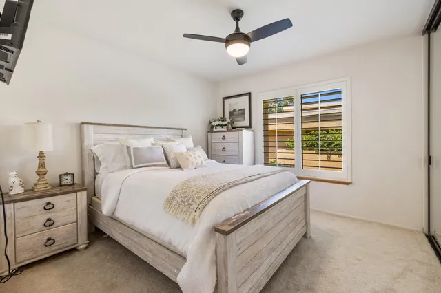 a bedroom with a large bed and a window