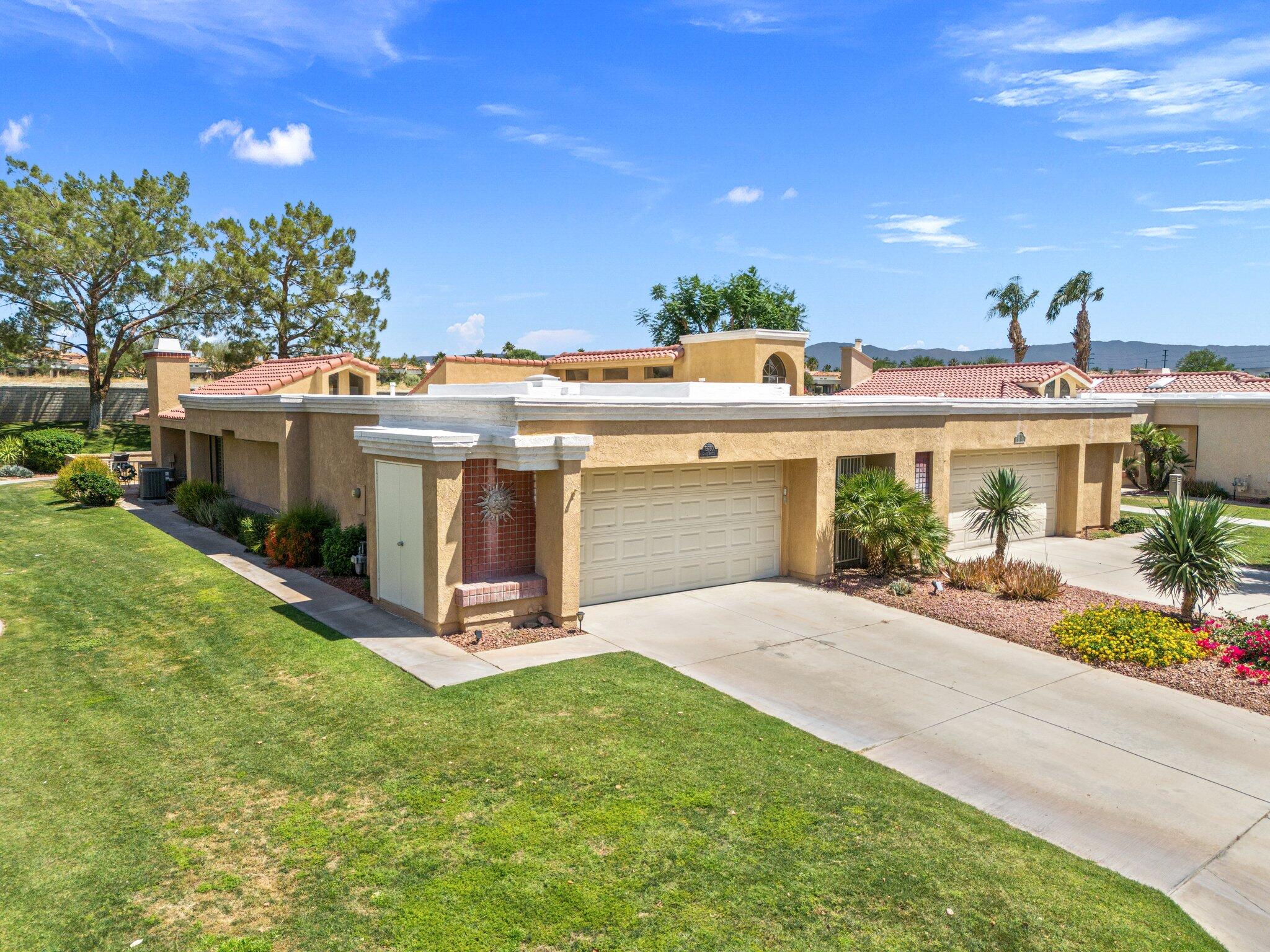 73750 Calle Bisque Palm Desert, CA 92260 - Photo 2 of 40 a view of a house with a patio and a yard
