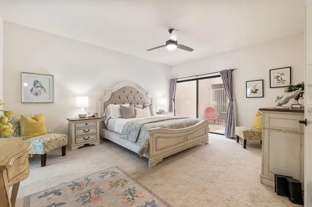 a bedroom with a bed couch and window