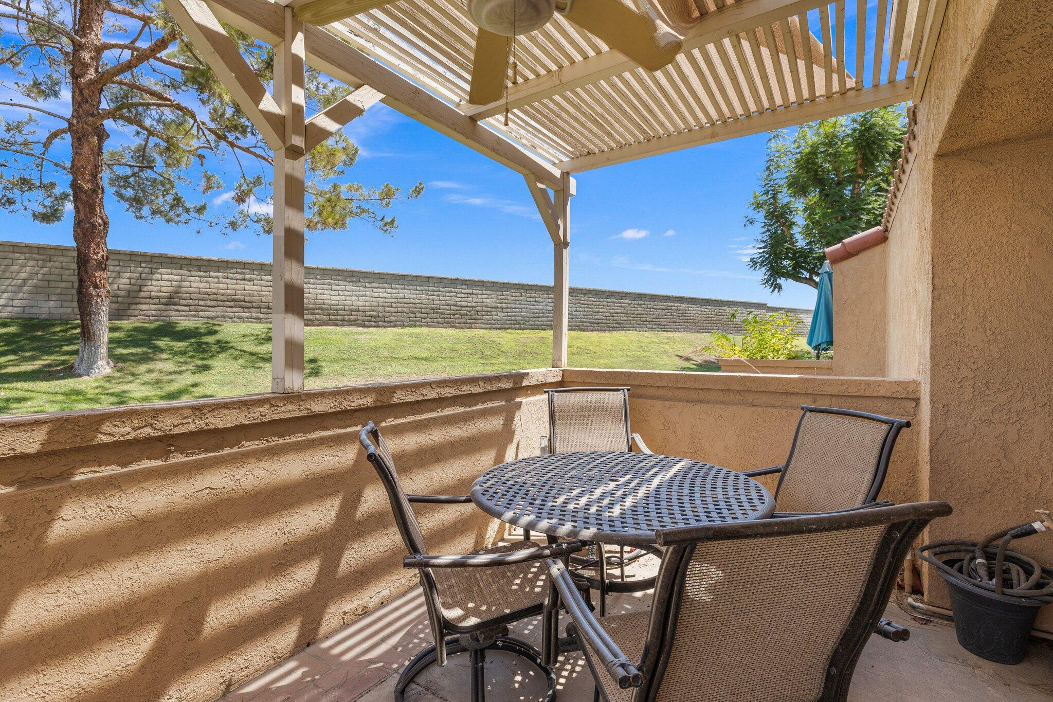 73750 Calle Bisque Palm Desert, CA 92260 - Photo 27 of 40 a view of a swimming pool with a table and chairs