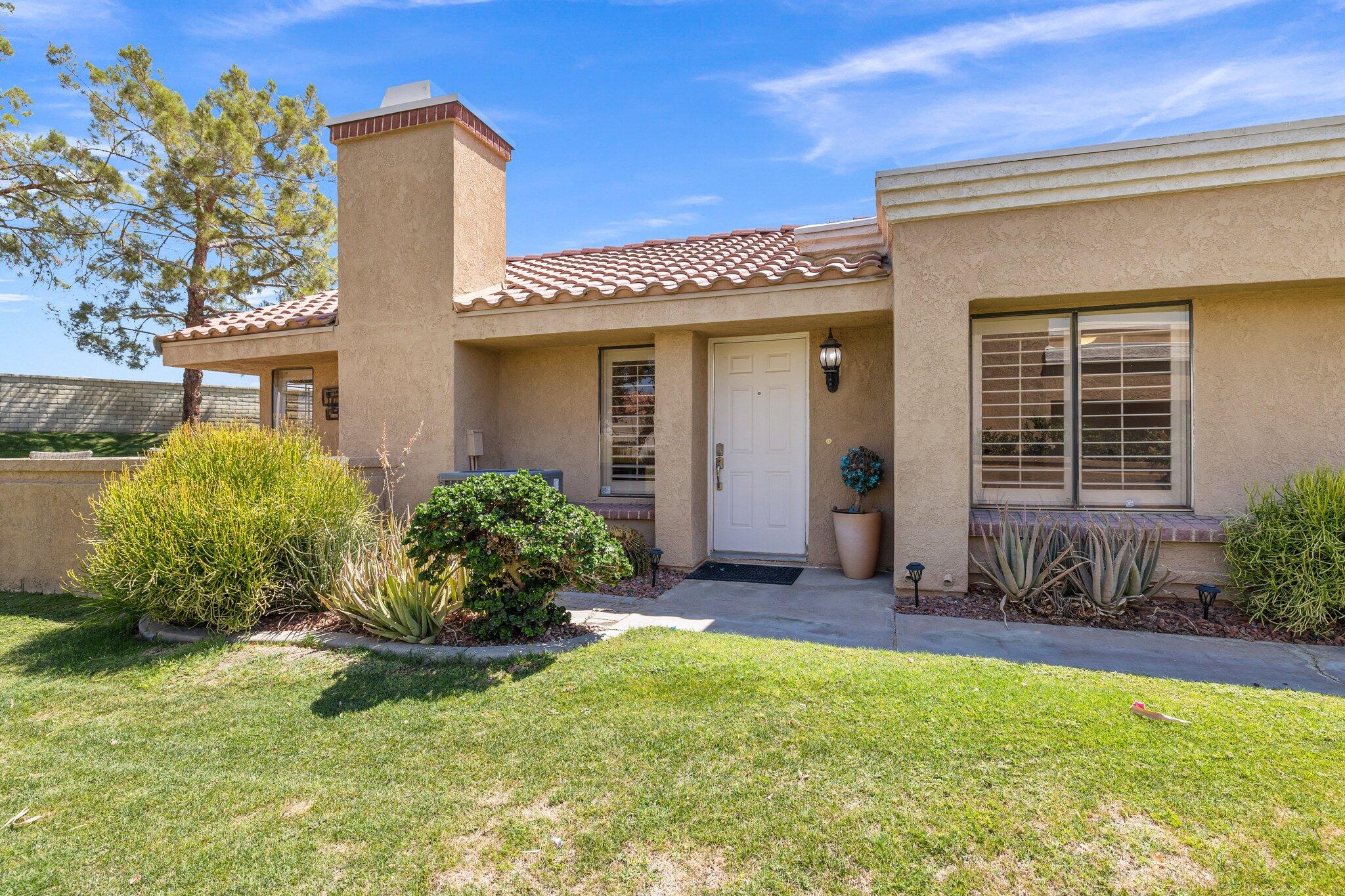 73750 Calle Bisque Palm Desert, CA 92260 - Photo 30 of 40 a front view of a house with garden
