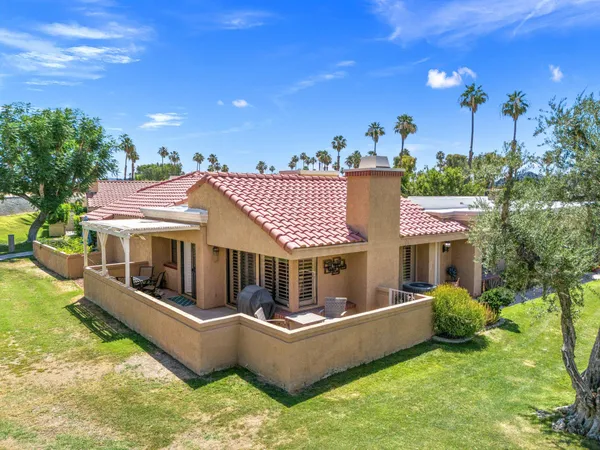 a view of a house with a couches in a patio