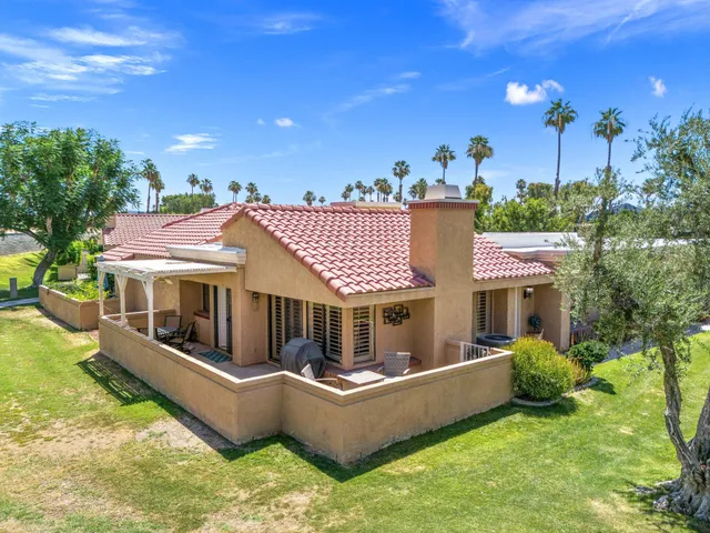 a view of a house with a couches in a patio