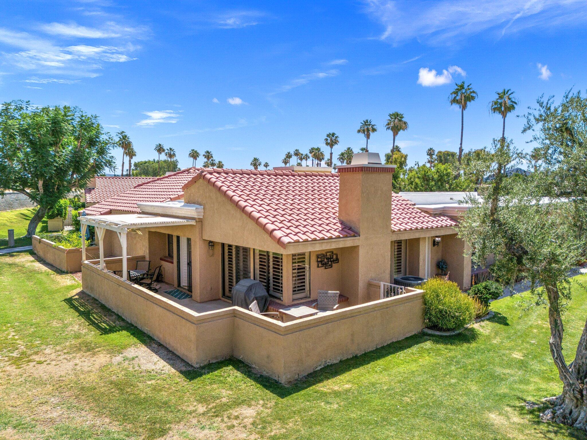 73750 Calle Bisque Palm Desert, CA 92260 - Photo 3 of 40 a view of a house with a couches in a patio