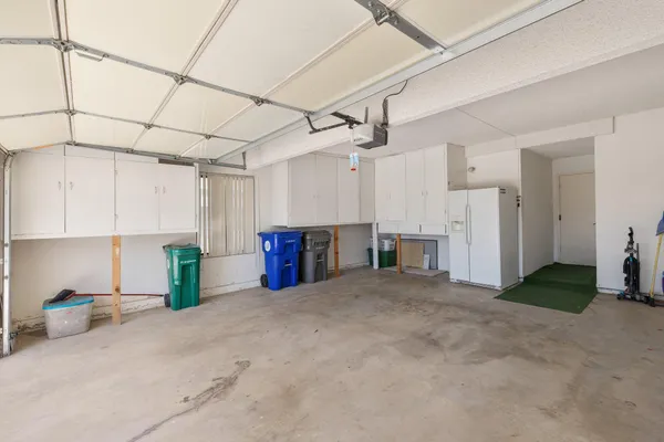 a view of a kitchen with refrigerator and cabinets