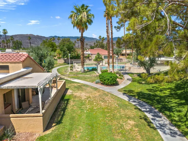 a view of swimming pool with a yard and mountain view
