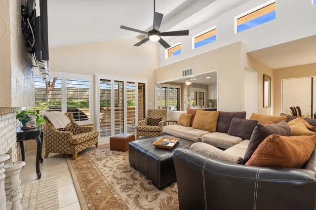 a living room with furniture fireplace and a flat screen tv