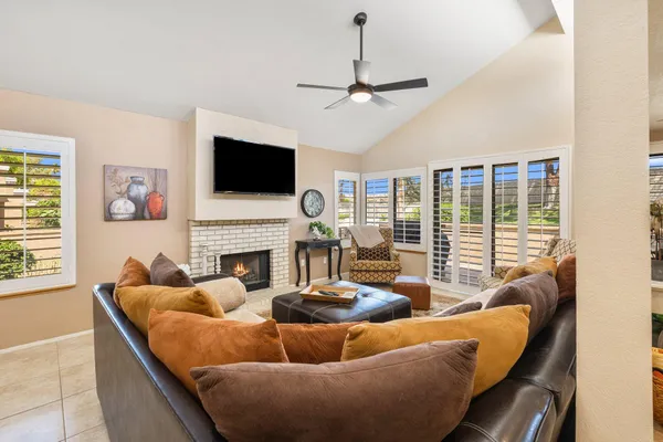 a living room with fireplace furniture and a flat screen tv