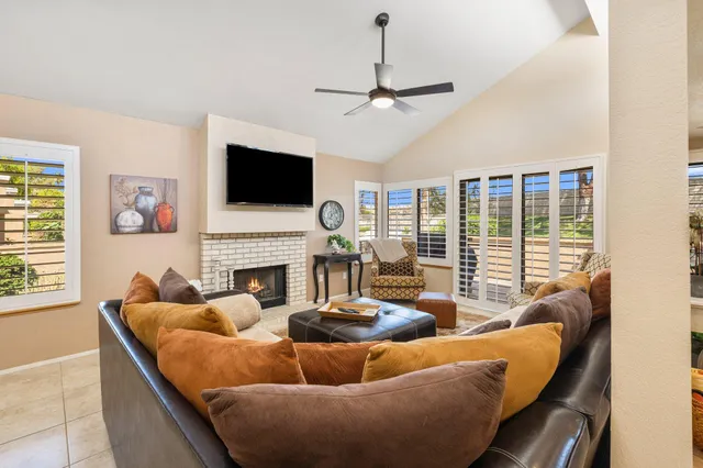 a living room with fireplace furniture and a flat screen tv